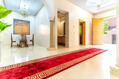 a living room with a red rug on the floor at Peaceful Marrakech Villa 4 Bedrooms Private Pool in Marrakech