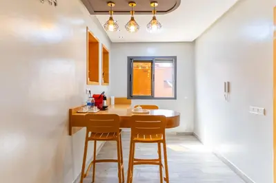a kitchen with a wooden table and two chairs at Peaceful Marrakech Villa 4 Bedrooms Private Pool in Marrakech