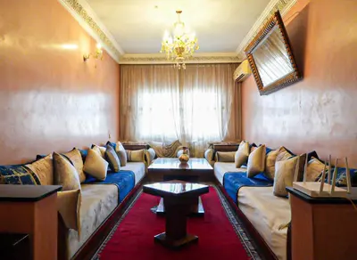 a living room with a couch and a chandelier at Stylish Moroccan Apartment Near Majorelle Garden, Wi-Fi, Free Airport Shuttle in Marrakech