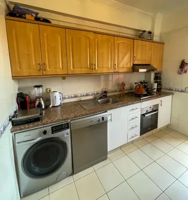 a kitchen with a washing machine and a sink at Stylish Moroccan Apartment Near Majorelle Garden, Wi-Fi, Free Airport Shuttle in Marrakech
