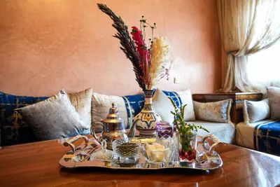 a table with a tray with vases and flowers on it at Stylish Moroccan Apartment Near Majorelle Garden, Wi-Fi, Free Airport Shuttle in Marrakech