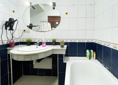 a bathroom with two sinks and a tub and a mirror at Stylish Moroccan Apartment Near Majorelle Garden, Wi-Fi, Free Airport Shuttle in Marrakech