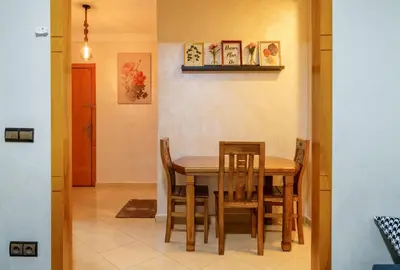 a dining room with a table and chairs at Appartement Cosy et calme in Marrakech