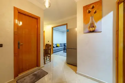 a hallway with a door and a vase on the wall at Appartement Cosy et calme in Marrakech