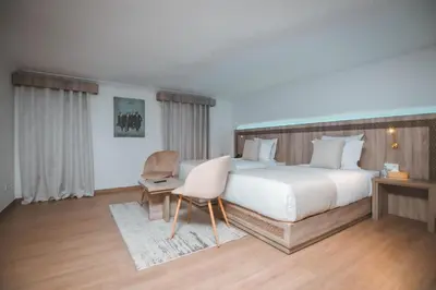 a large bedroom with a large bed and a chair at 555 Hotel Clubbing Adults Only in Marrakech