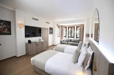 a hotel room with two beds and a television at 555 Hotel Clubbing Adults Only in Marrakech