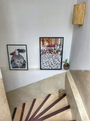 a stairway with three pictures on the wall and a stair case at Riad privé, 5 suites et piscine in Marrakech