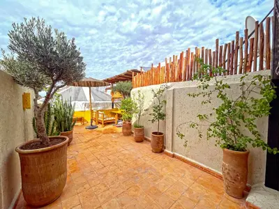 a patio with a bunch of potted plants and a fence at Riad privé, 5 suites et piscine in Marrakech