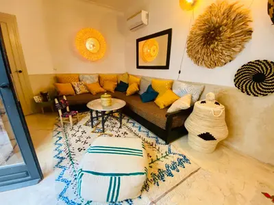 a living room with a couch and a table at Riad privé, 5 suites et piscine in Marrakech