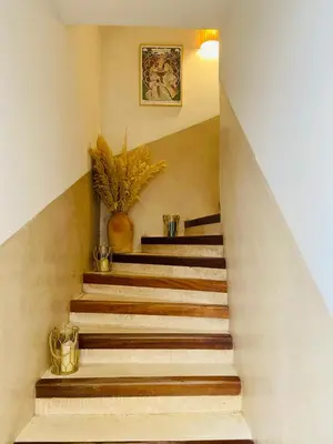 a set of stairs with a plant on the top at Riad privé, 5 suites et piscine in Marrakech