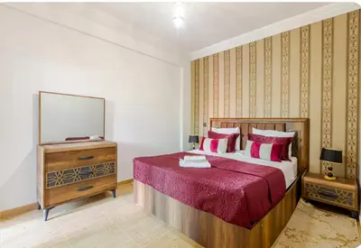 a bedroom with a bed and a dresser and a mirror at Charming Two-Bedroom Apartment in Marrakesh Gueliz in Marrakech