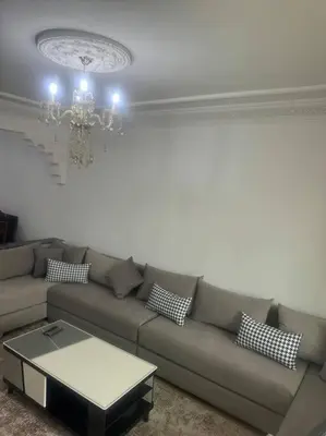 a living room with a couch and a chandelier at Charming Two-Bedroom Apartment in Marrakesh Gueliz in Marrakech