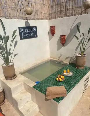 a bathroom with a tub with a bowl of fruit in it at Private Riad 4 Bedrooms With Free Breakfast and Heated Plunge Pool in Marrakech