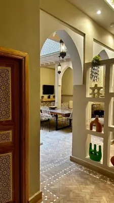 an archway in a living room with a dining room at Private Riad 4 Bedrooms With Free Breakfast and Heated Plunge Pool in Marrakech