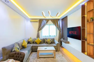 a living room with a couch and a table at Step into Elegance - Marrakech in Marrakech