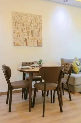 a dining room table with chairs and a painting at Step into Elegance - Marrakech in Marrakech