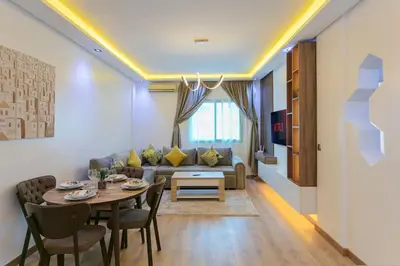 a living room with a table and a couch at Step into Elegance - Marrakech in Marrakech
