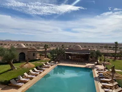 a resort with a swimming pool and lounge chairs at Luxury Villa Rêve D'ahlam à MARRAKECH in Oulad Boudene