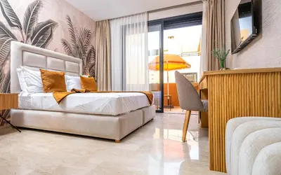a bedroom with a bed and a desk in it at Villa ZINA I Luxe I Piscine chauffée I Wifi I Proche centre Ville in Marrakech