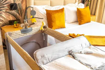 two beds in a room with yellow pillows at Villa ZINA I Luxe I Piscine chauffée I Wifi I Proche centre Ville in Marrakech