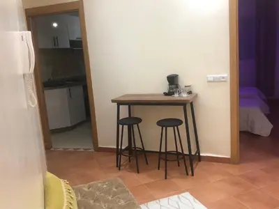 a small table and two stools in a room at appartement moderne,gueliz in Marrakech