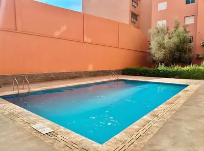 a swimming pool in front of a building at appartement moderne,gueliz in Marrakech