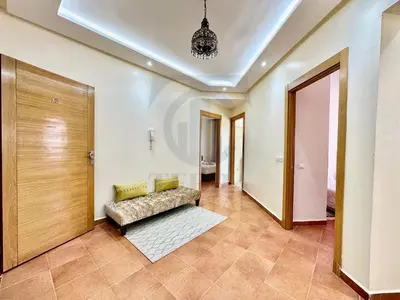 a living room with a couch and a door at appartement moderne,gueliz in Marrakech