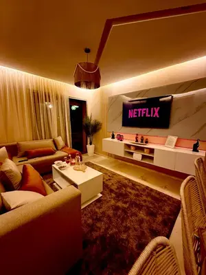 a living room with a netflix sign on the wall at Elegant Apartment with Pool, Clim & Wi-Fi - 7min Gueliz in Marrakech