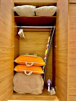 a closet with two bunk beds and a surfboard at Elegant Apartment with Pool, Clim & Wi-Fi - 7min Gueliz in Marrakech