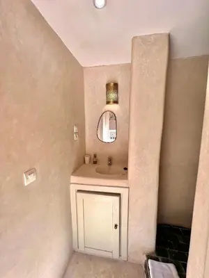 a bathroom with a sink and a mirror at Riad Ouatine in Marrakech