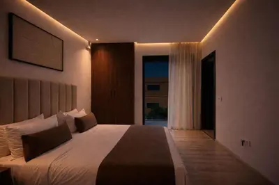 a bedroom with a large bed and a large window at villa 105 golf noria piscine chauffée in Marrakech