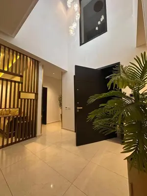 a hallway with a potted plant in a building at villa 105 golf noria piscine chauffée in Marrakech