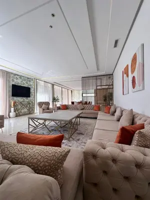 a large living room with couches and a table at villa 105 golf noria piscine chauffée in Marrakech
