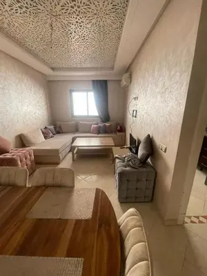 a large living room with a couch and a table at Appartement calme près de Gueliz Marrakech in Marrakech