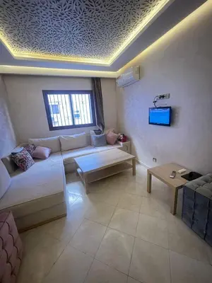 a living room with a couch and a table at Appartement calme près de Gueliz Marrakech in Marrakech
