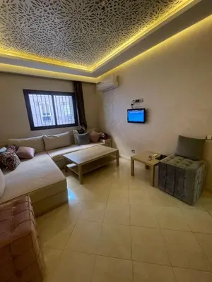 a living room with a couch and a table at Appartement calme près de Gueliz Marrakech in Marrakech