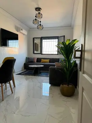 a living room with a couch and a plant at Marrakech top 1 in Marrakech