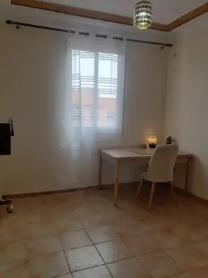 a room with a table and a chair and a window at Marrakesh 3 Bedroom Oasis in Marrakech