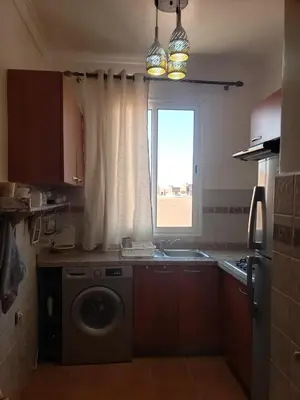a kitchen with a washing machine and a window at Marrakesh 3 Bedroom Oasis in Marrakech