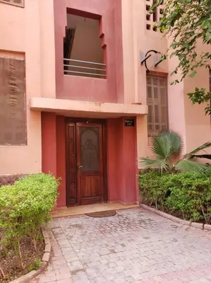 a pink building with a wooden door on it at Marrakesh 3 Bedroom Oasis in Marrakech