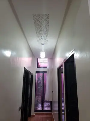 a hallway with two doors and a window in a room at Step into our little oasis in Marrakech
