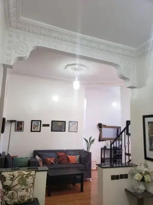 a living room with a couch and a tv at Step into our little oasis in Marrakech