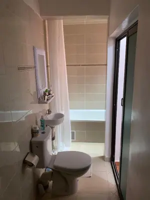 a bathroom with a toilet and a sink at Step into our little oasis in Marrakech