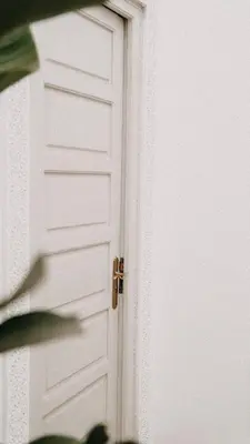 a white door with a gold door knob at Riad KRÈME in Marrakech