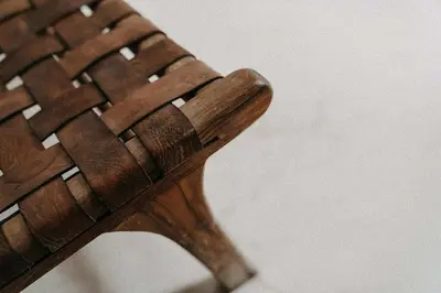 a close up of the end of a wooden bench at Riad KRÈME in Marrakech
