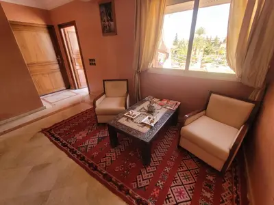 a living room with a table and two chairs at MELBARI Cosy-Appart in Marrakech
