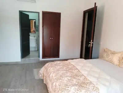 a bedroom with a bed and a large mirror at Medina-in auberge in Marrakech