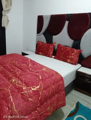 a bedroom with a large bed with red pillows at Medina-in auberge in Marrakech