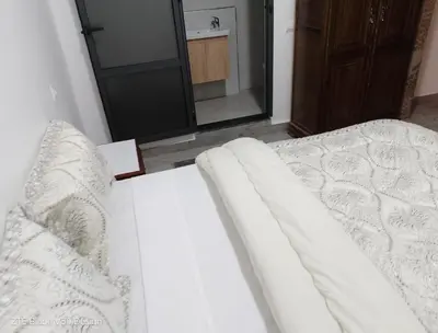 a white bed in a room with a mirror at Medina-in auberge in Marrakech