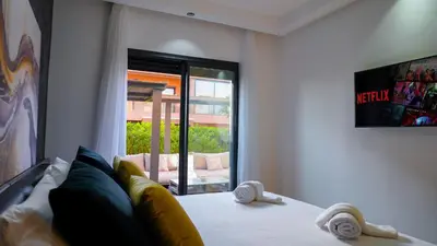 a bedroom with a white bed with a window at Havre de Paix à Noria Golf Marrakech in Marrakech